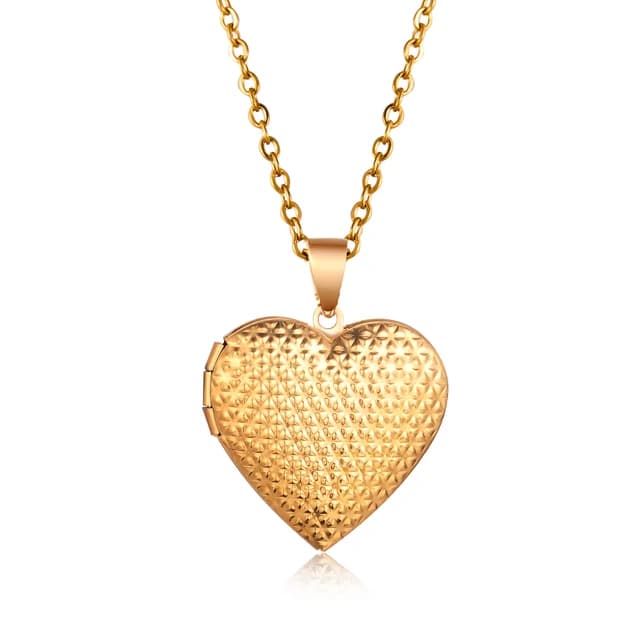 A gold heart locket with a dotted lid.