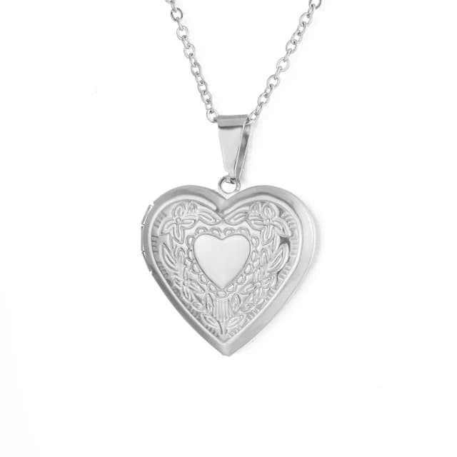 A silver heart locket with a heart engraved on the lid.