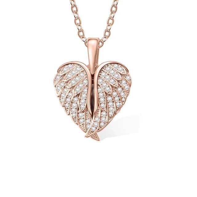 A rose gold heart locket framed by angel wings.