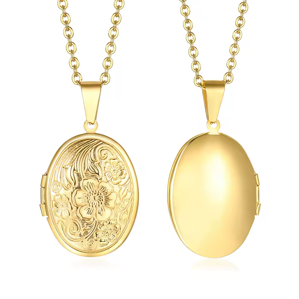 A gold oval locket with a floral lid.